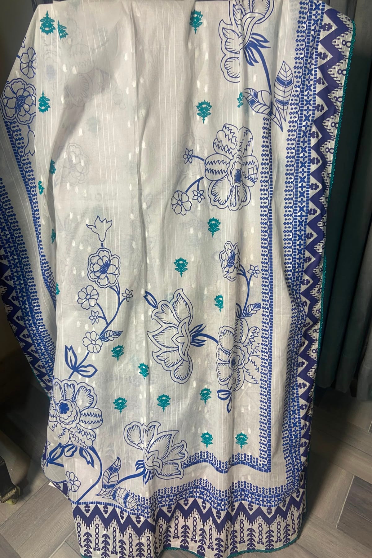 Full layout of 2.75 yards dooria lawn dupatta with blue block-printed floral patterns and four-sided lace trim by Zariyat by Sumera.