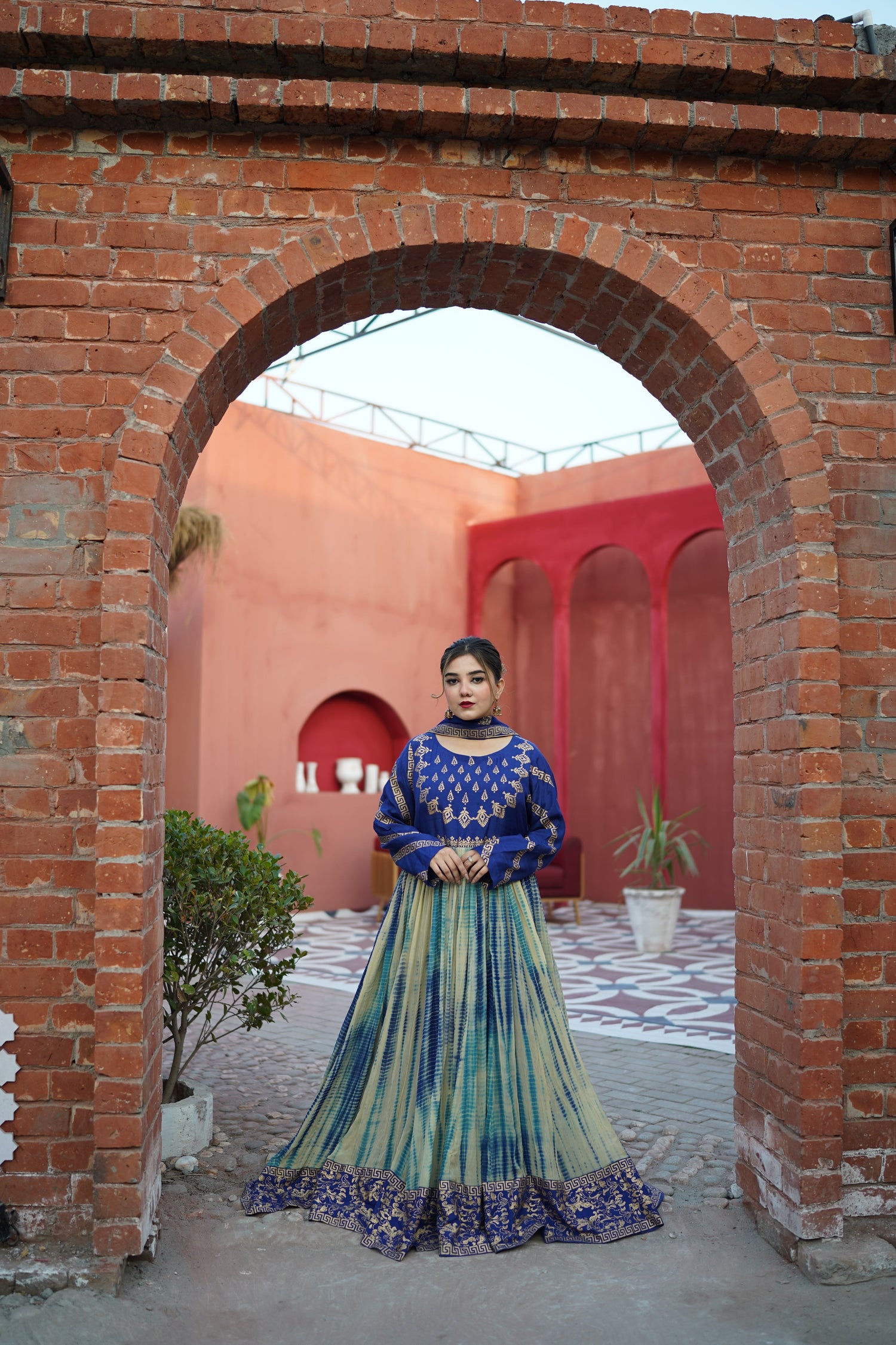 Elegant royal blue and gold printed festive suit by Zariyat. Features a block-printed bodice paired with a unique tie-dye flared skirt. The perfect blend of traditional heritage and modern grace for any celebration.