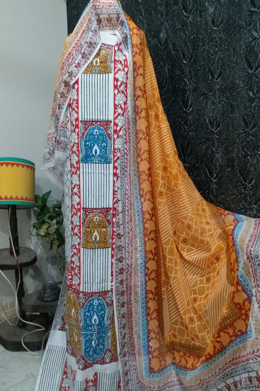 Close-up of a 3-piece unstitched traditional block print suit in white, mustard yellow, and blue patterns on fine lawn fabric with a matching dupatta displayed on a mannequin."