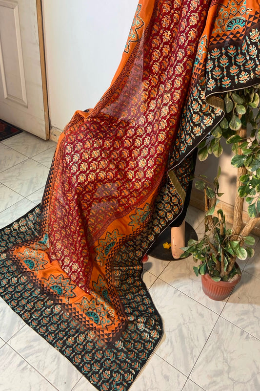 Traditional rust orange and deep maroon raw silk dupatta with heavy block printing and black patterned borders.