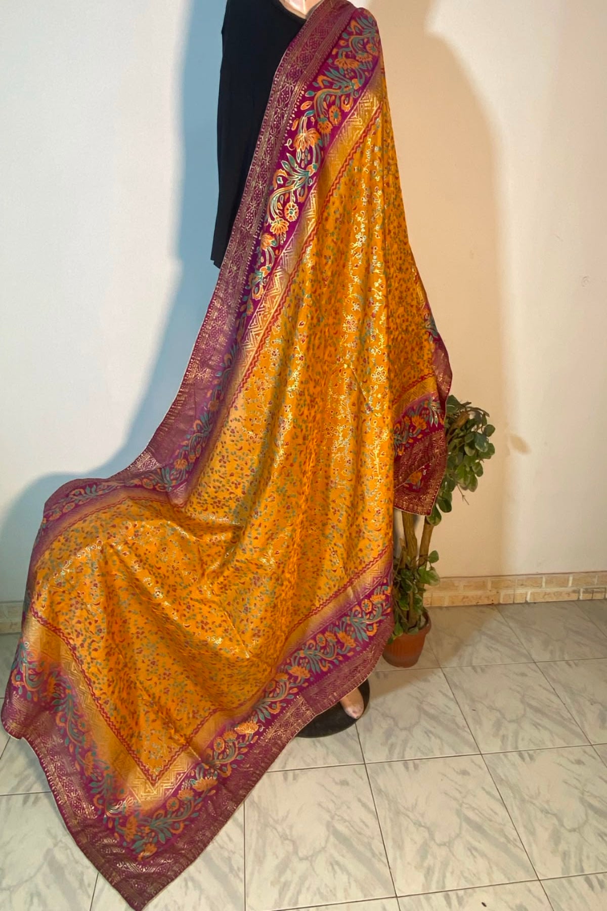 Antique mustard yellow raw silk dupatta featuring intricate gold block printing and a rich plum purple patterned border.