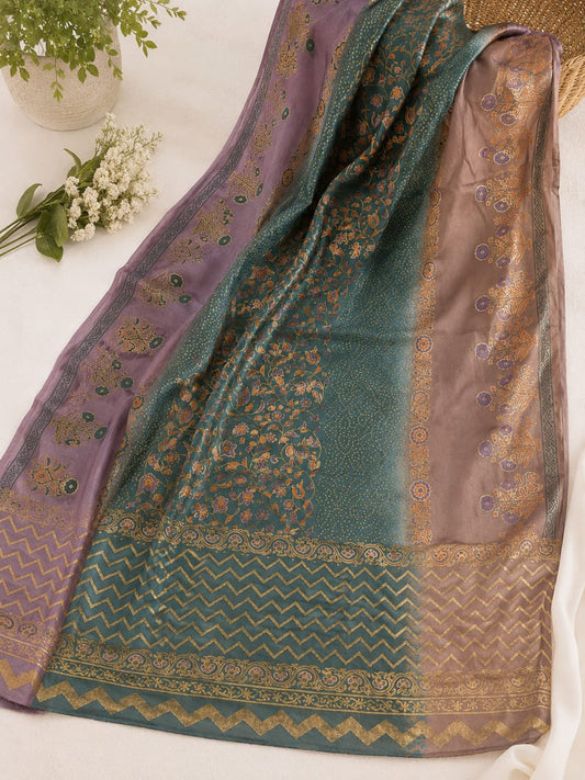 A traditional medium  silk block print dhupata draped on a white surface, featuring a teal green body with gold floral patterns, a lavender purple border, and a bronze-gold chevron and ornamental border.