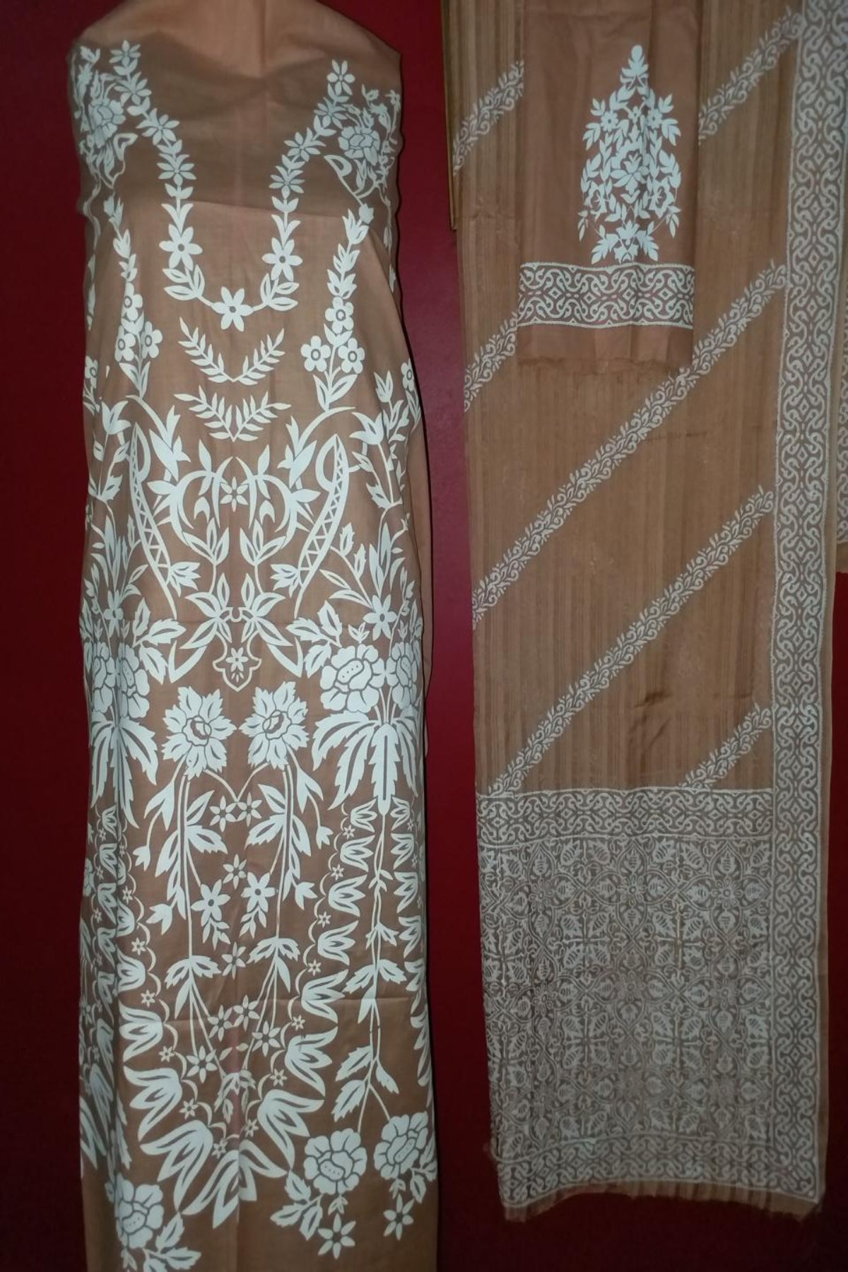 Two-piece unstitched fine lawn suit in an earthy beige color with large white floral block prints on the shirt, displayed next to a striped lawn dooria dupatta.