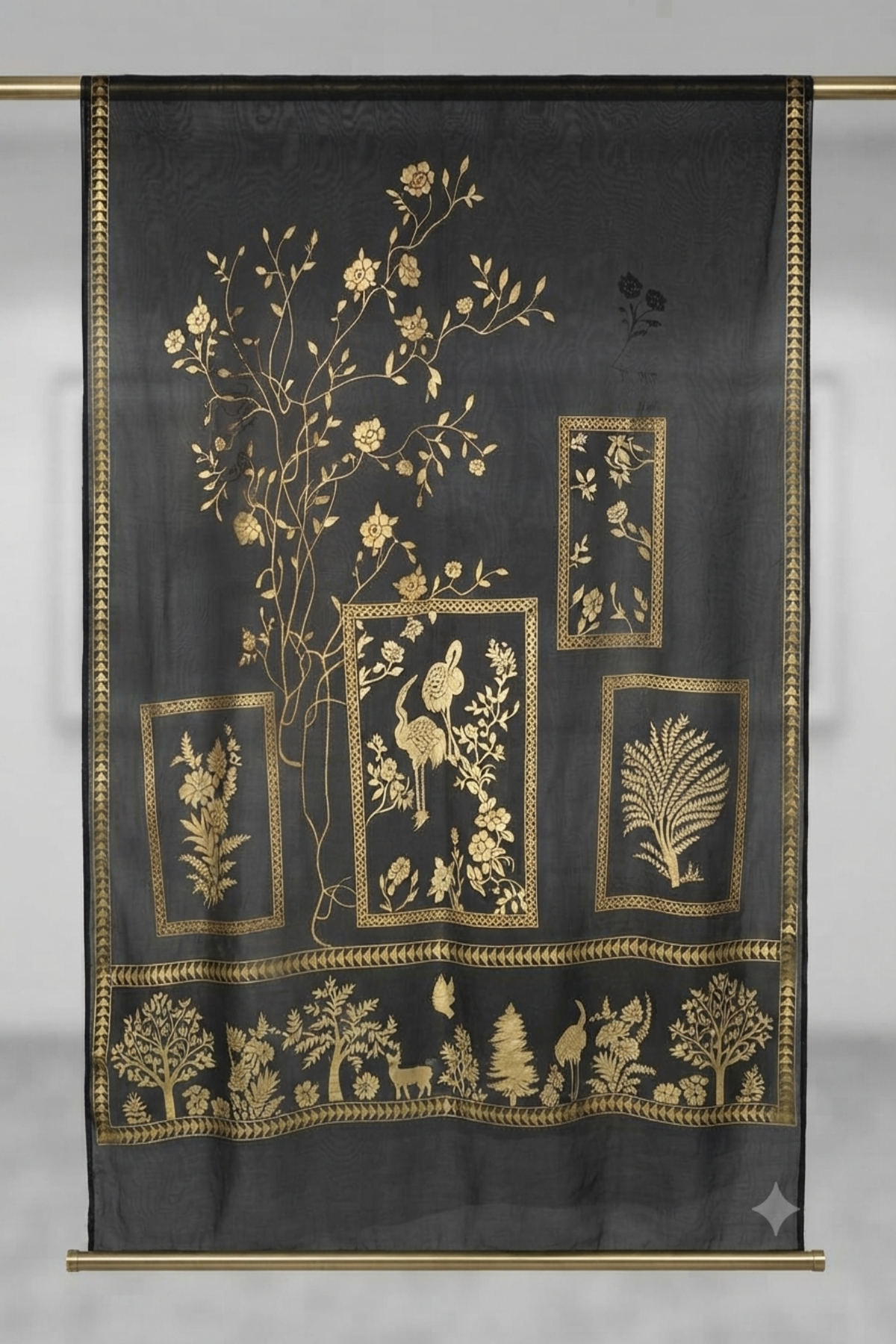 Black fabric dupatta featuring intricate metallic gold block-print floral, tree, bird, and deer motifs displayed in a studio setting.