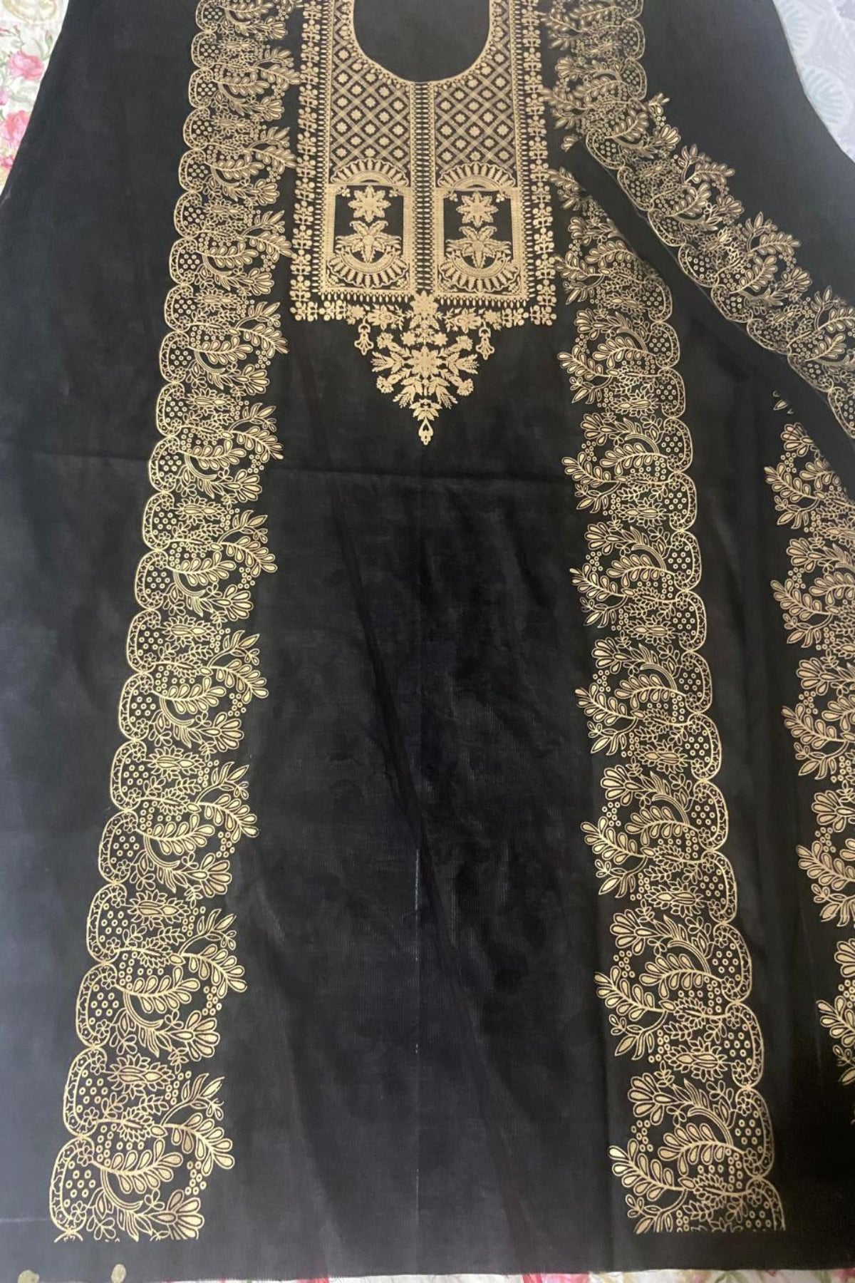 Unstitched black block print shirt with intricate gold neckline and panel designs.