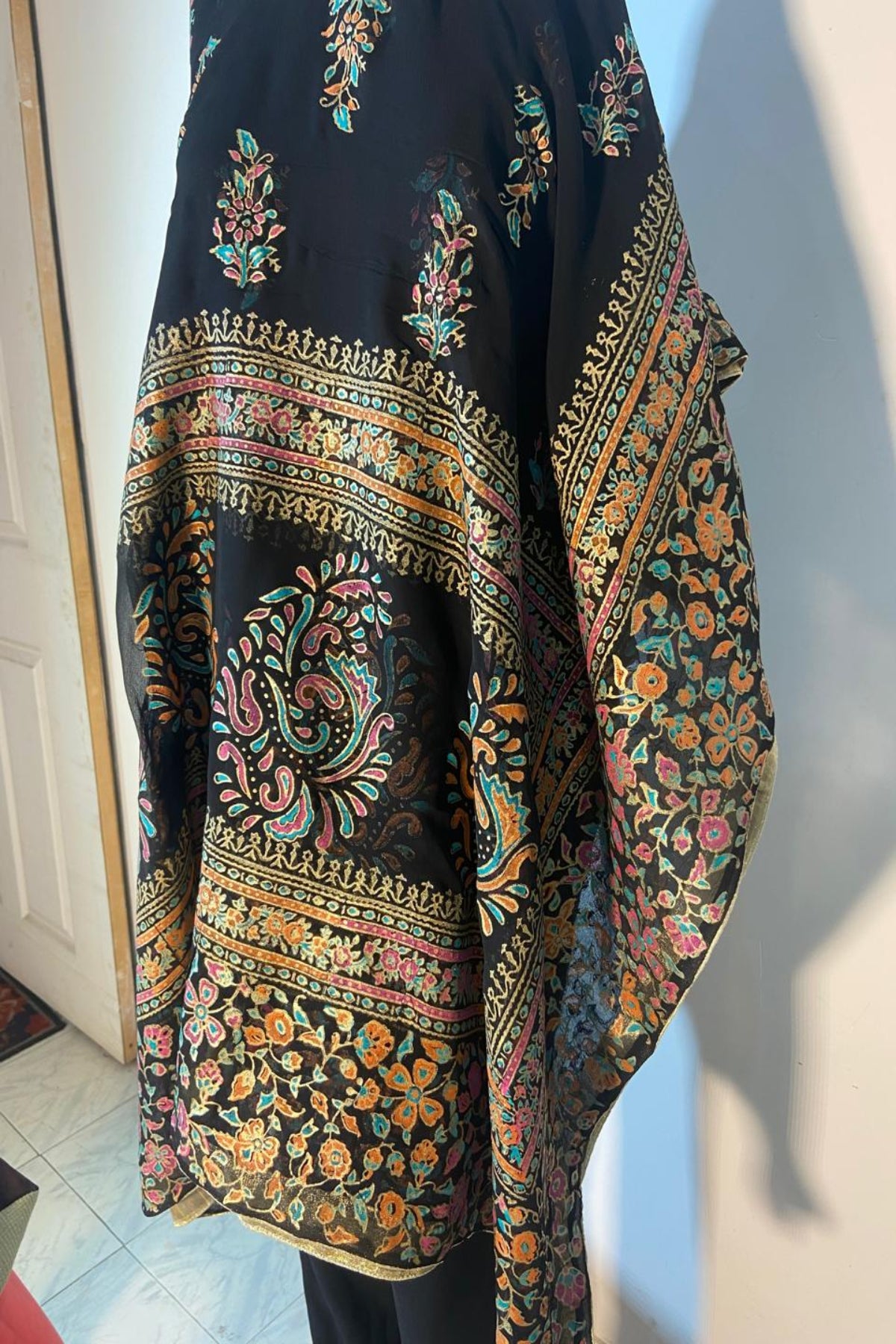 Black fine medium silk block print dupatta featuring vibrant multi-color floral motifs and a golden massuri border.