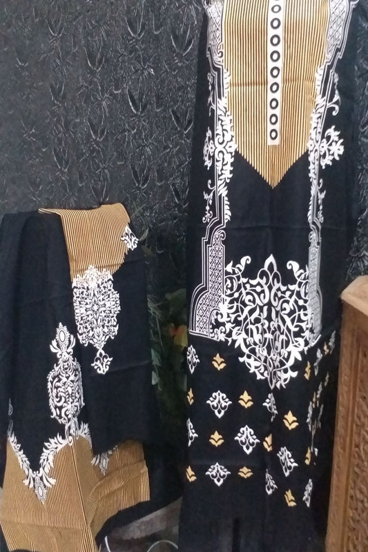 An unstitched 3.5-yard fine lawn shirt fabric in black with a mustard yellow striped neck panel and white block printed floral motifs.