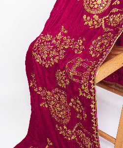 Full view of a luxury burgundy velvet shawl featuring ornate gold floral and cage embroidery.