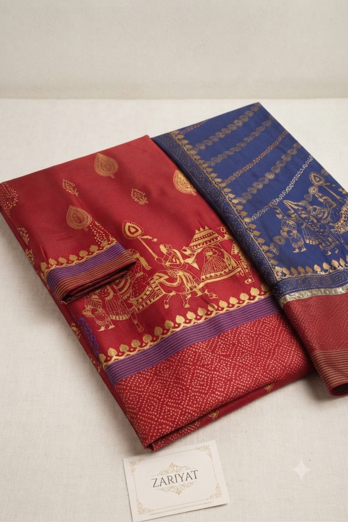 Folded fabric set of a maroon and blue traditional suit featuring gold printed patterns by Zariyat by Sumera.