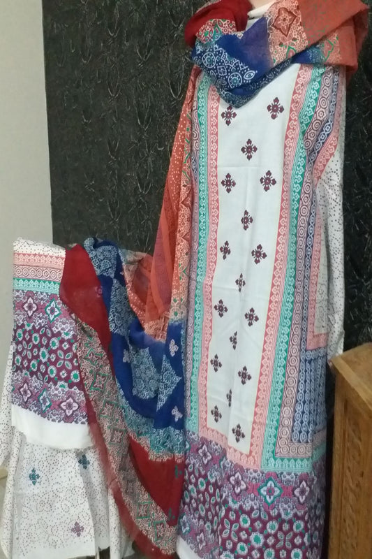 Three-piece unstitched fine lawn suit with an off-white base featuring maroon, royal blue, and orange block printed panels alongside a multi-colored chiffon dupatta.