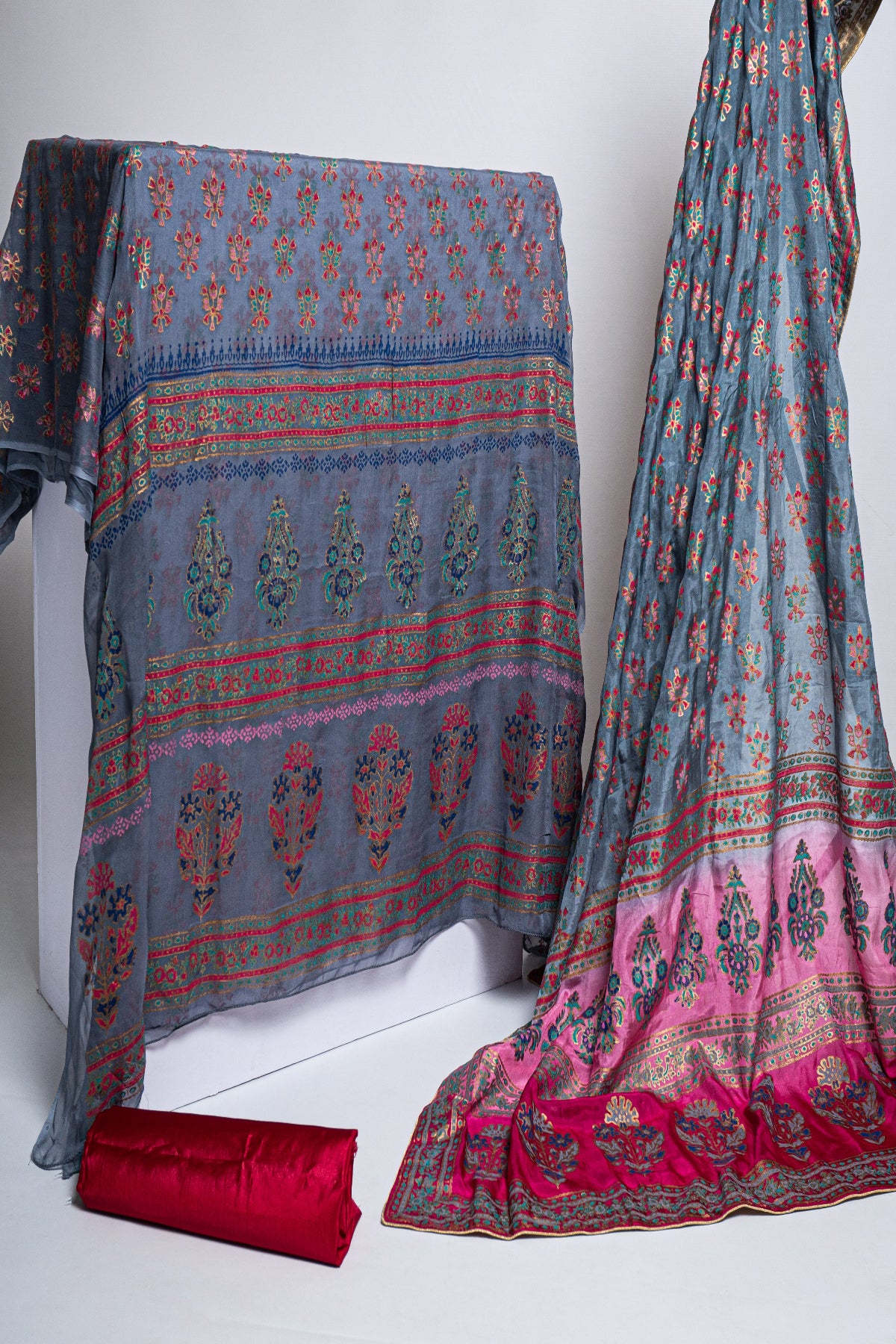 Premium 3-piece unstitched grey raw silk block print suit with a 3-shade medium silk dupatta and magenta trouser fabric, perfect for Pakistani festive formal wear