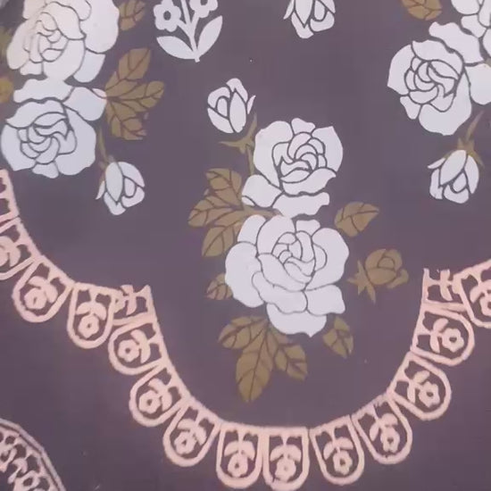 Flat lay view of black lawn kurti showcasing traditional hand block-printed floral patterns