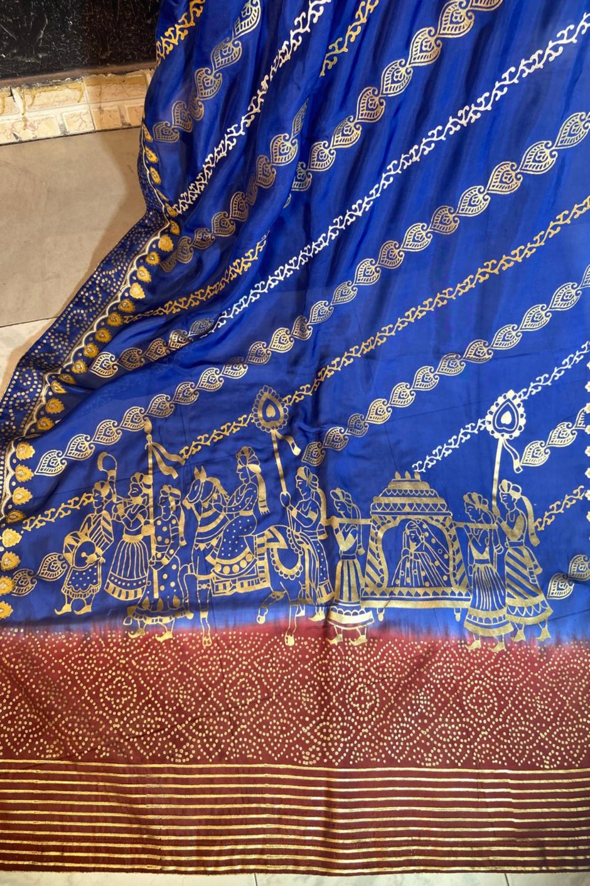 Close-up view of royal blue silk dupatta showing intricate gold block printing and four-sided massuri trim