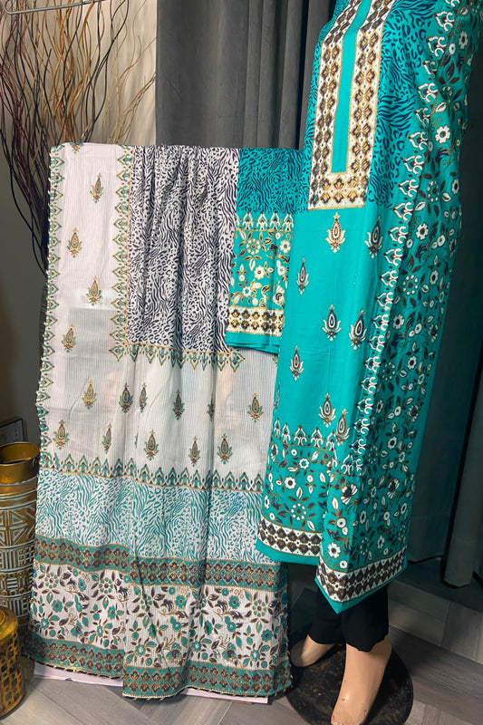 Turquoise and white printed unstitched 3-piece suit displayed on a mannequin showcasing the shirt, trousers, and dupatta.