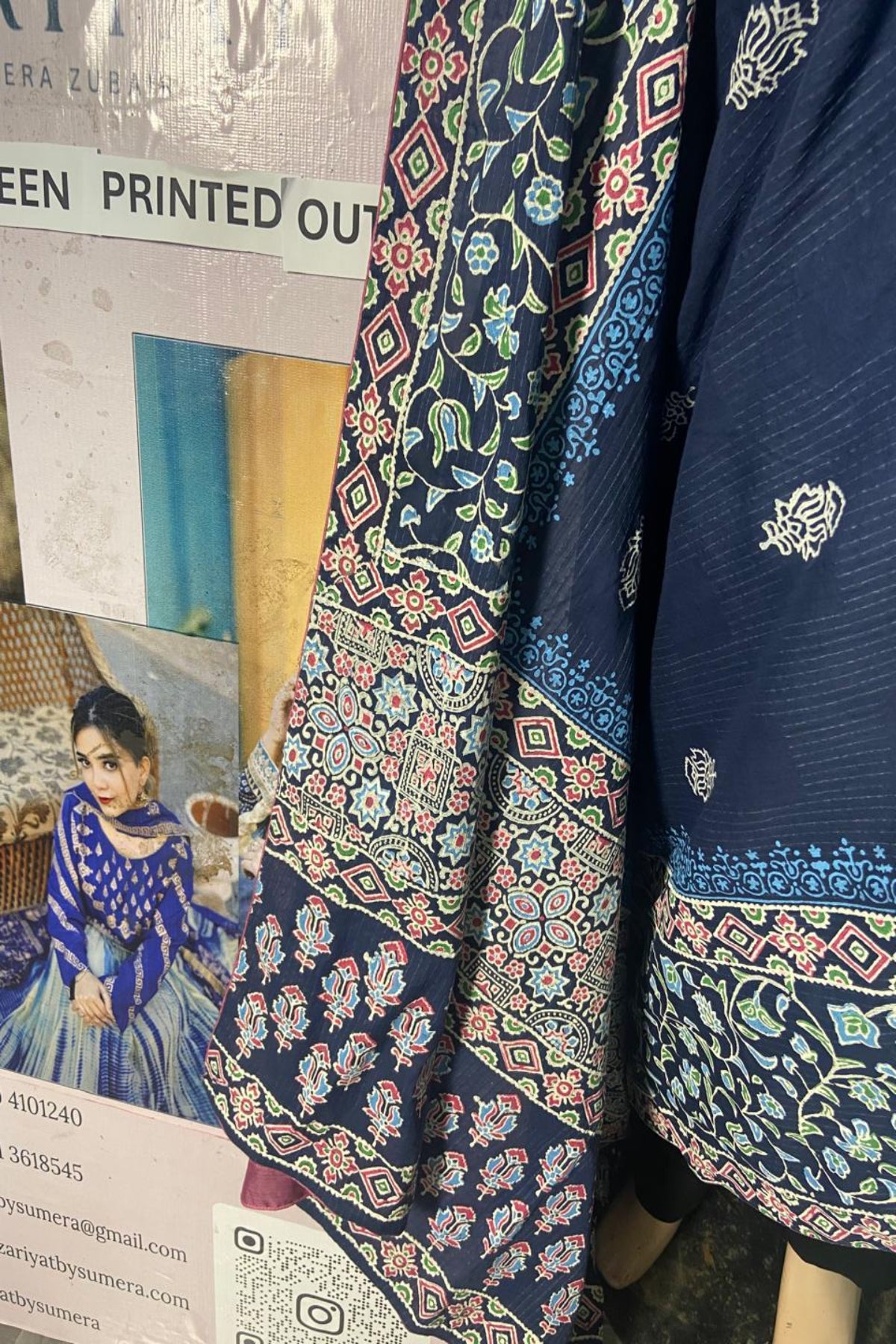 Close-up view of the traditional Ajrak style multi-color block print borders and motifs on dooria lawn fabric by Zariyat by Sumera.