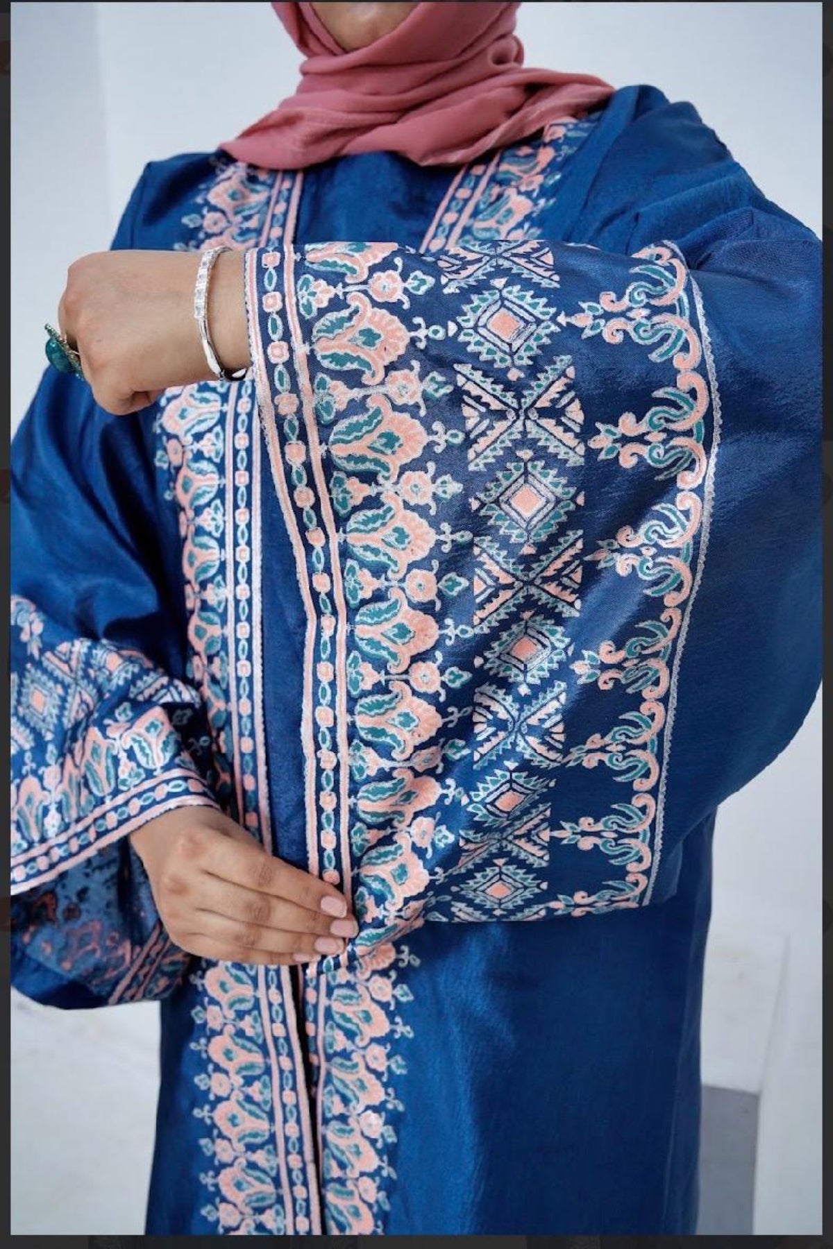 Detailed close-up of handcrafted block print broad sleeves on a luxury Katan Silk long dress by Zariyat by Sumera.