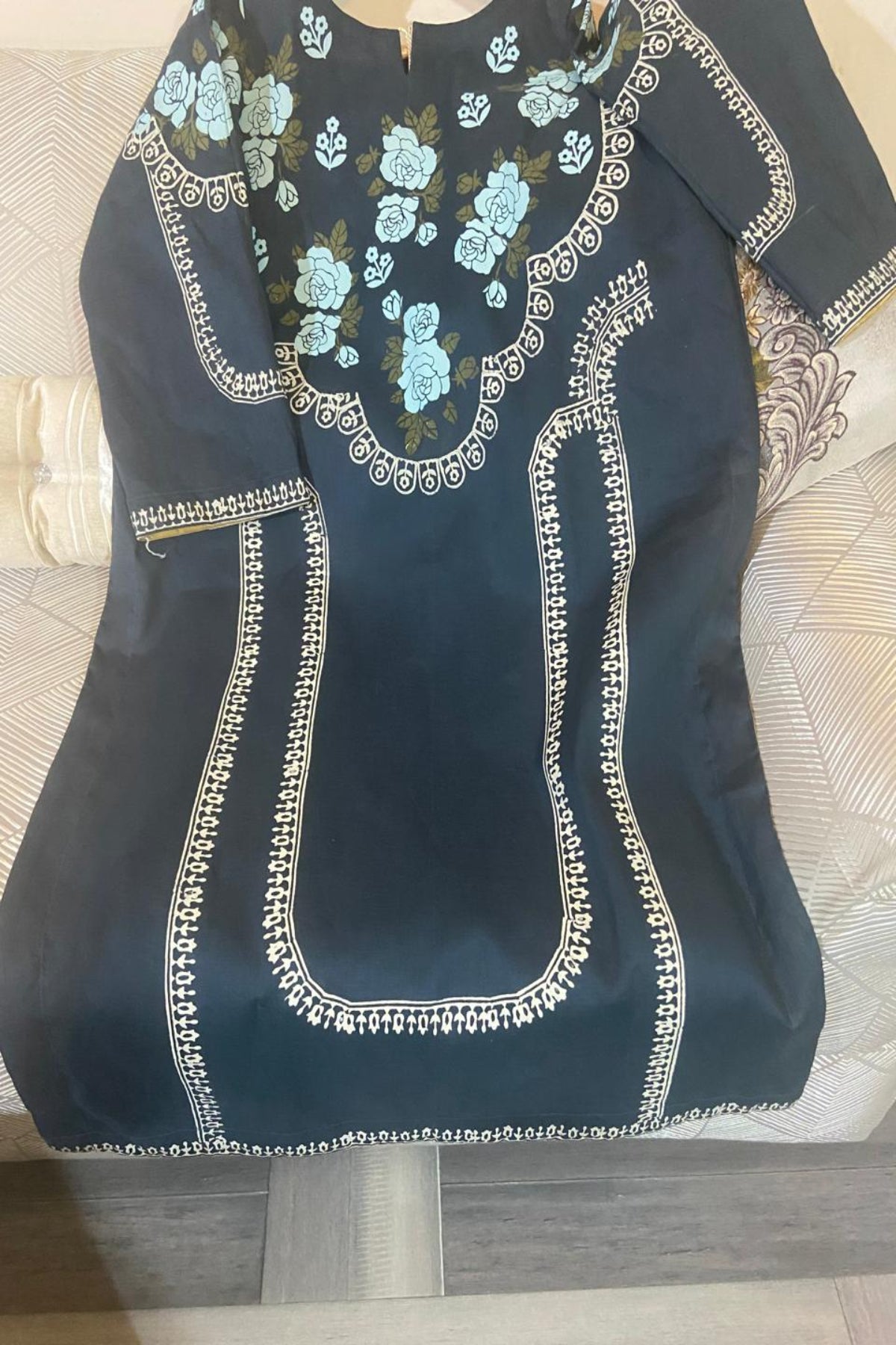 Flat lay view of black lawn kurti showcasing traditional hand block-printed floral patterns
