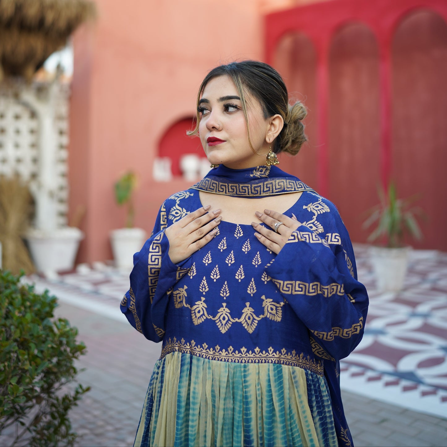 A beautiful woman wearing a royal blue and gold hand-block printed outfit by Zariyat by Sumera, showcasing traditional ethnic fashion.