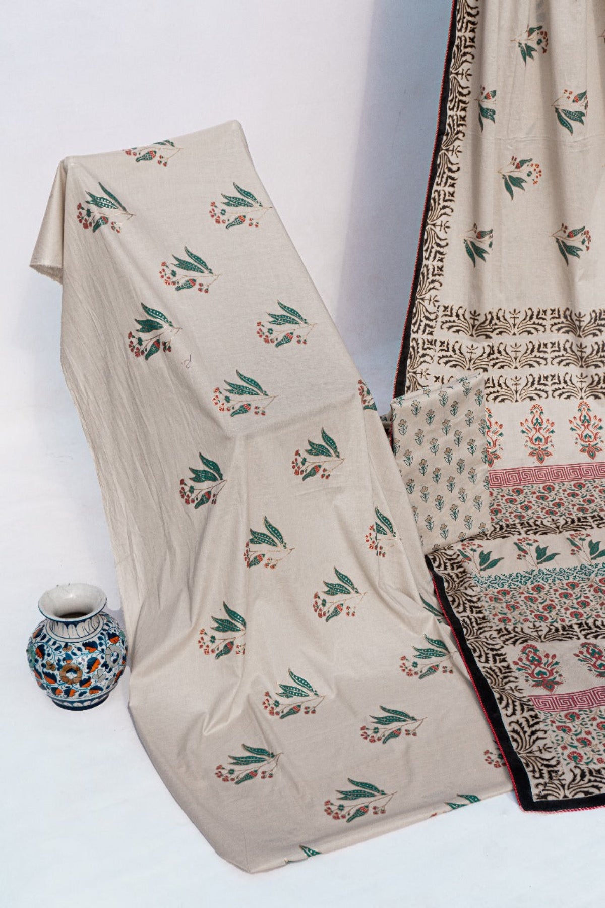 Elegant off-white lawn saree with floral hand block prints and geometric borders by Zariyat by Sumera