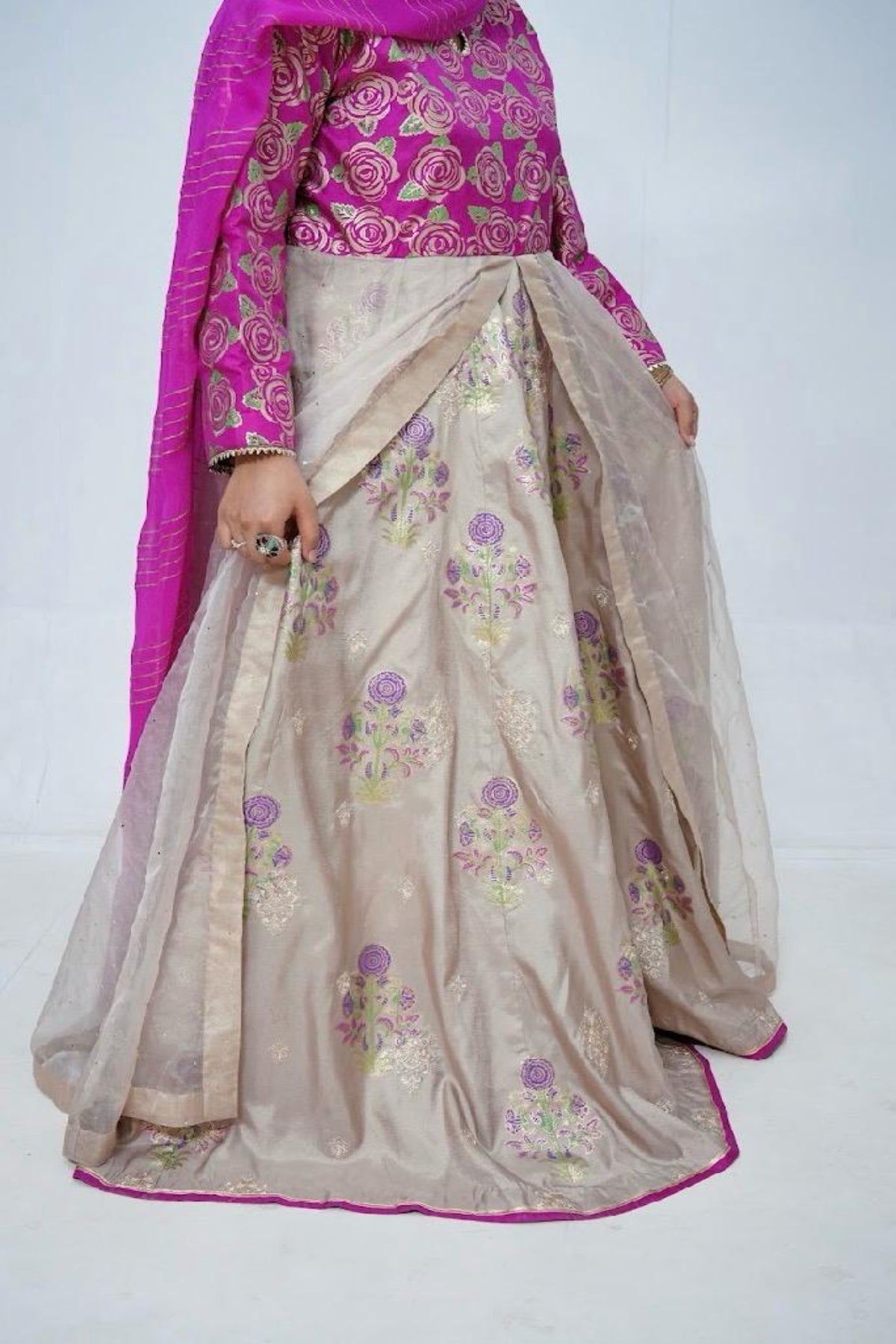 Full flare view of luxury stitched front open block print long dress with organza layers, Zari work, and handcrafted floral design.