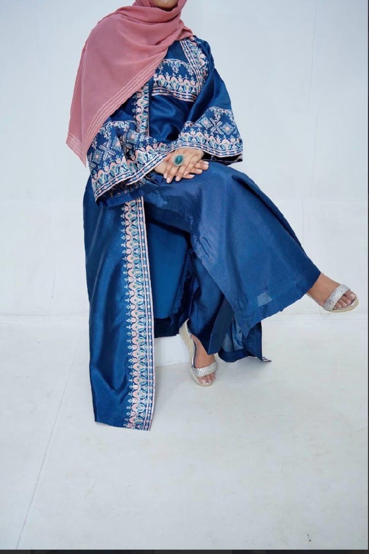 Side view of a luxury 2-piece stitched block print long dress in premium Katan Silk featuring wide sleeves and elegant handcrafted detailing by Zariyat by Sumera.