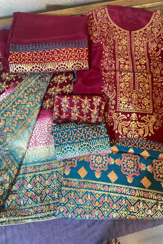 A magenta raw silk lawn suit from Zariyat by Sumera featuring intricate block print patterns paired with a printed dupatta.