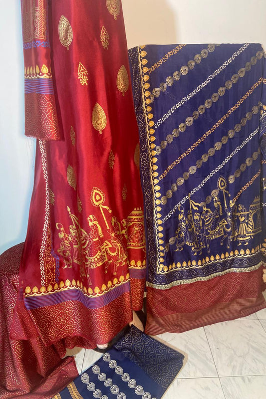 A 3-piece Zariyat by Sumera suit featuring intricate traditional block print patterns in gold on a maroon shirt and deep blue dupatta, complete with matching bottoms