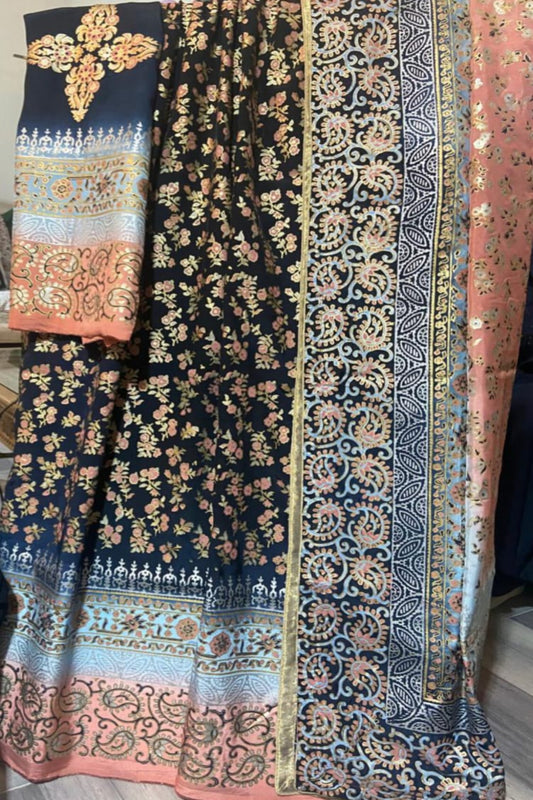 A Zariyat by Sumera suit featuring a navy blue fabric base with intricate multi-colored floral and paisley block print motifs throughout.