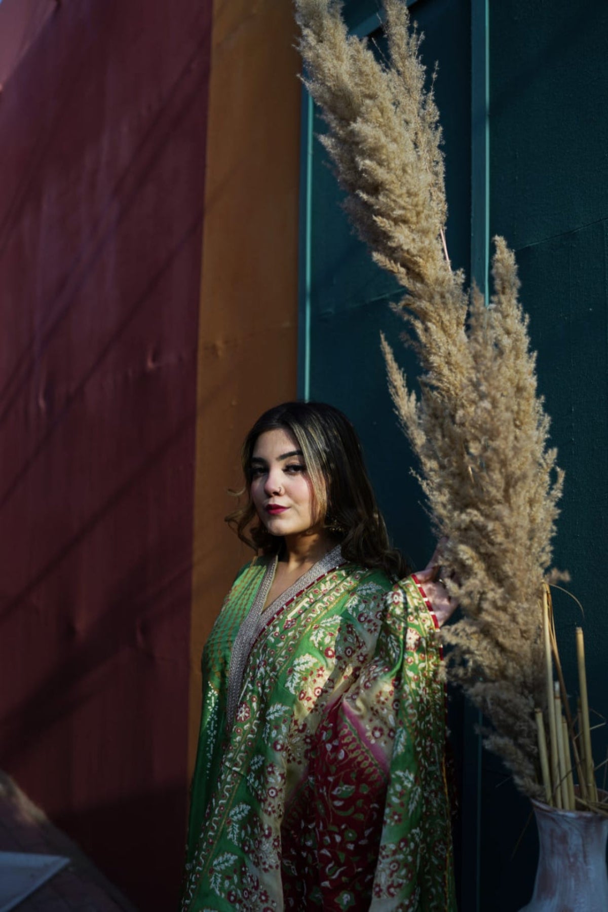 A woman modeling a Zariyat unstitched fine raw silk suit with a decorative 3-tone dyed chiffon dupatta.